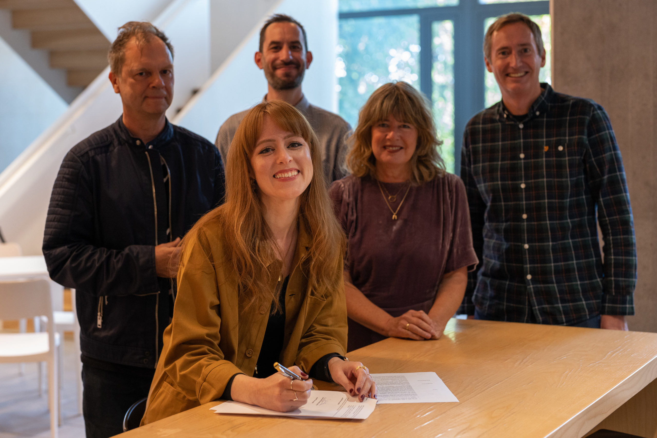Hannah Peel photographed signing her recording contract with Real World Records for the release of the album The Unfolding, her new project in collaboration with Paraorchestra.